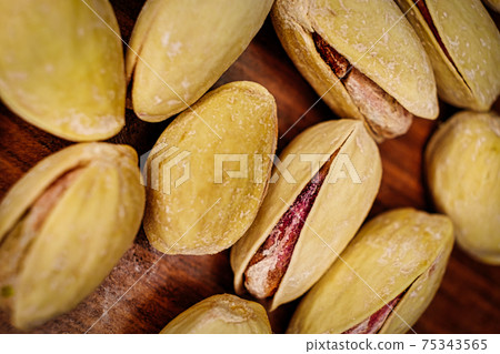 Salted pistachio nuts open shells macro image. Salted pistachio nuts open shells macro image. 75343565
