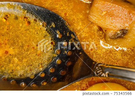 Asian muchroom curry with Sauce and serving spoon, macro image Asian muchroom curry with Sauce and serving spoon, macro image 75343566