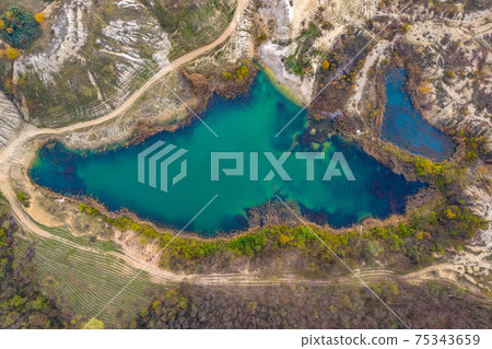 Aerial drone shot of a lake, opencast mine Aerial drone shot of a lake, opencast mine 75343659