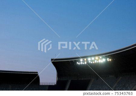 Stadium lights against blue sky 75343763
