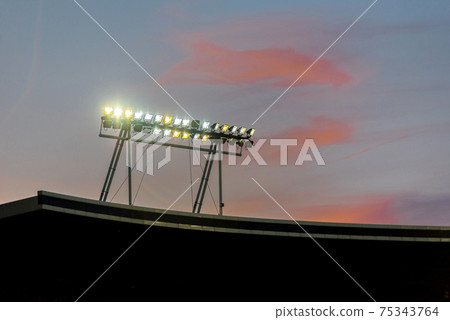 Stadium lights against blue sky 75343764