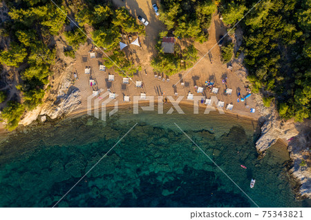 Aerial drone view of beach umbrellas and sunbeds 75343821
