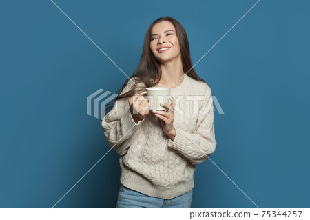 Happy woman drinking coffee and laughing on banner background Happy woman drinking coffee and laughing on banner background 75344257