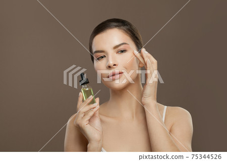 Healthy woman spa model with cosmetic oil Healthy woman spa model with cosmetic oil 75344526