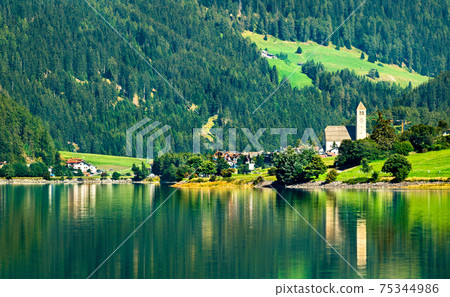 Church in Reschen am See or Resia, a village on Lake Reschen in South Tyrol, Italy Church in Reschen am See or Resia, a village on Lake Reschen in South Tyrol, Italy 75344986