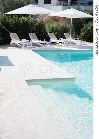 Pool with clear blue water on sunny day in residential the yard 75345259