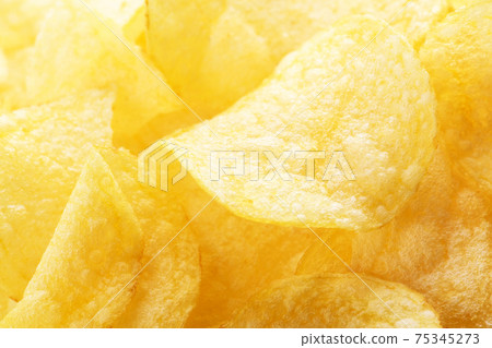 Yellow salted potato chips as background. Chips texture Yellow salted potato chips as background. Chips texture 75345273
