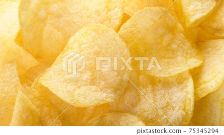 Yellow salted potato chips as background. Chips texture Yellow salted potato chips as background. Chips texture 75345294