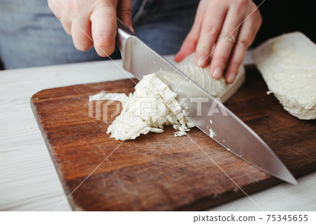 Woman preparing healthy vegetarian food in kitchen Woman preparing healthy vegetarian food in kitchen 75345655