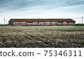 Old rustic farm on a background of blue sky 75346311