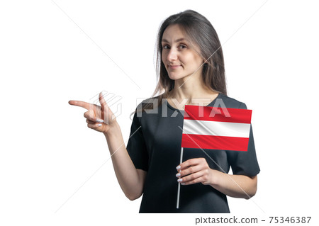 Happy young white woman holding flag Austria and points to the left isolated on a white background Happy young white woman holding flag Austria and points to the left isolated on a white background 75346387