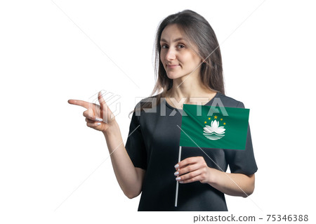 Happy young white woman holding flag Macau and points to the left isolated on a white background Happy young white woman holding flag Macau and points to the left isolated on a white background 75346388