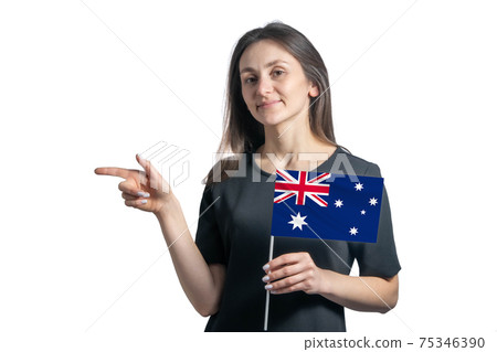 Happy young white woman holding flag Australia and points to the left isolated on a white background Happy young white woman holding flag Australia and points to the left isolated on a white background 75346390