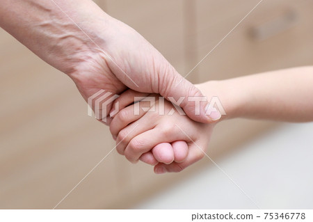 Granddaughter and senior citizen hold hands in 3 generations 75346778