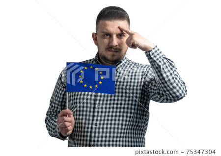 White guy holding a flag of European Union and a finger touches the temple on the head isolated on a white background White guy holding a flag of European Union and a finger touches the temple on the head isolated on a white background 75347304