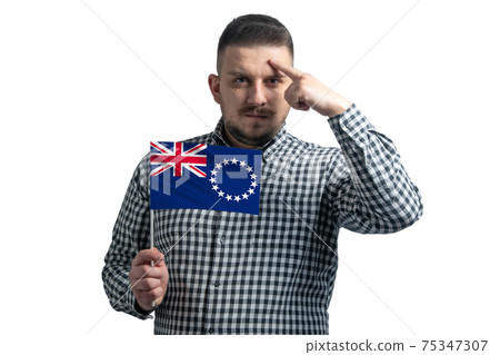 White guy holding a flag of Cook Islands and a finger touches the temple on the head isolated on a white background White guy holding a flag of Cook Islands and a finger touches the temple on the head isolated on a white background 75347307