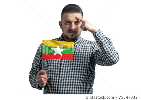 White guy holding a flag of Myanmar and a finger touches the temple on the head isolated on a white background White guy holding a flag of Myanmar and a finger touches the temple on the head isolated on a white background 75347332