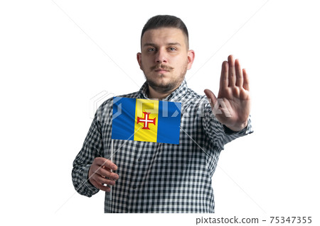 White guy holding a flag of Madeira and with a serious face shows a hand stop sign isolated on a white background 75347355