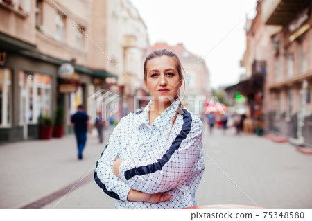Happy young woman looking around in the city Happy young woman looking around in the city 75348580