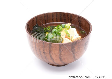 Japanese miso soup with tofu and seaweed wakame in a wooden bowl. Healthy food concept Japanese miso soup with tofu and seaweed wakame in a wooden bowl. Healthy food concept 75349596