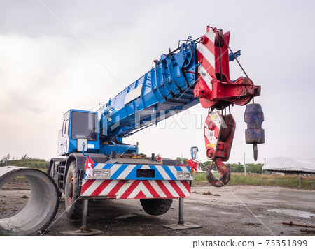Construction site crane is lifting a led signboard for advertisement Construction site crane is lifting a led signboard for advertisement 75351899