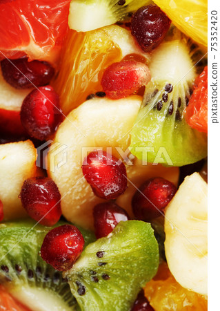 Fruit salad close-up in full screen, as a background. Fruit salad close-up in full screen, as a background. 75352420