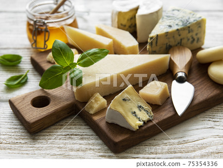 Various types of cheese  on a white wooden  background 75354336