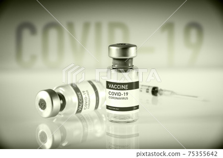 Covid-19 vaccine bottle and syringe on a black and white background 75355642