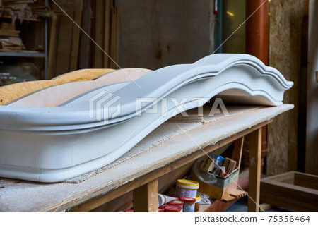 Joinery. Carved crown molding of a classical wardrobe. Furniture manufacture Joinery. Carved crown molding of a classical wardrobe. Furniture manufacture 75356464