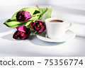 cup of blakc coffee and purple tulips 75356774
