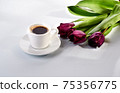 cup of blakc coffee and purple tulips 75356775