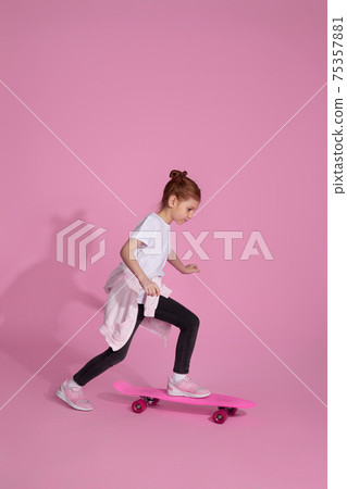Stylish little child girl with skateboard Stylish little child girl with skateboard 75357881