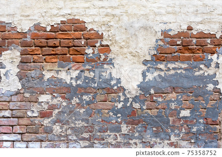 Grunge empty red stonewall background. Old brick wall texture. Painted distressed wall surface. Weathered building facade with old damaged plaster. Grungy brickwall. 75358752
