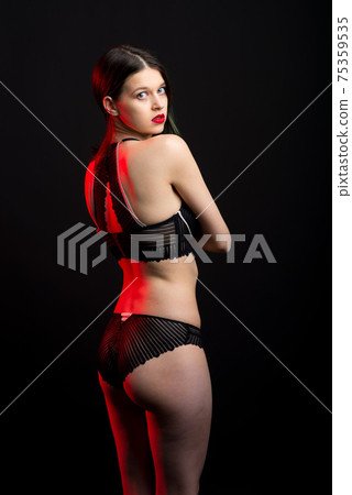 Vertical view photo beautiful shy lady in lace bikini boudoir bra panties. Tender skinny slim shape. 75359535