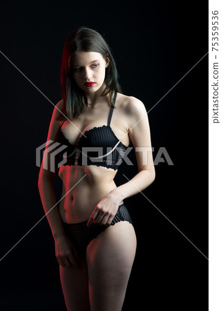 Vertical view photo beautiful shy lady in lace bikini boudoir bra panties. Tender skinny slim shape. Vertical view photo beautiful shy lady in lace bikini boudoir bra panties. Tender skinny slim shape. 75359536