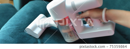 Use small vacuum cleaner to clean fabric on sofa. Use small vacuum cleaner to clean fabric on sofa. 75359864