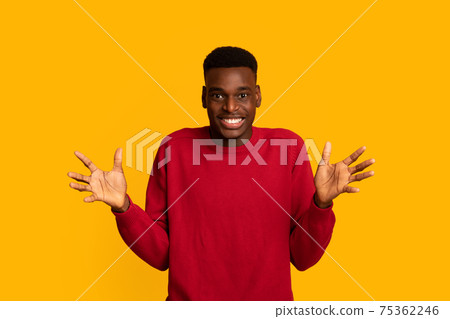 Portrait Of Cheerful African American Guy Spreading Hands In Excitement 75362246
