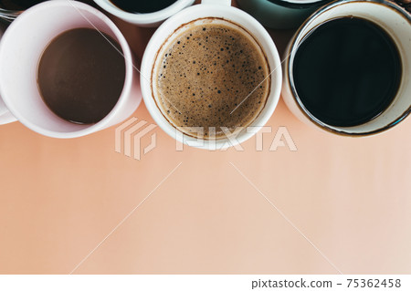 Multiple coffee cups on the beige background Multiple coffee cups on the beige background 75362458