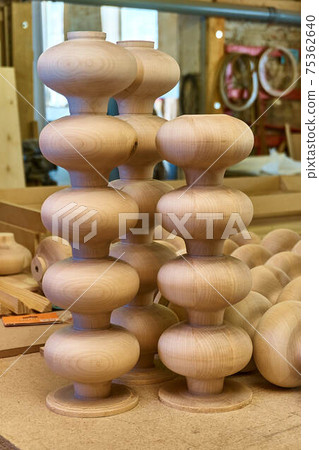 Lathe wooden legs in the turnip form folded on workbench Lathe wooden legs in the turnip form folded on workbench 75362640