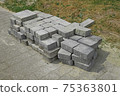 Pile of gray paving slabs stacked on the roadside 75363801