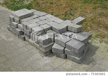 Pile of gray paving slabs stacked on the roadside Pile of gray paving slabs stacked on the roadside 75363801