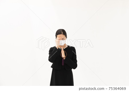 Burning incense, female mask in mourning clothes 75364069