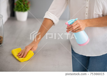 Close up picture of a woman disinfecting the surfaces Close up picture of a woman disinfecting the surfaces 75366015