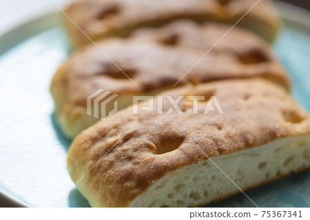 Super-ripe focaccia served on a plate Super-ripe focaccia served on a plate 75367341