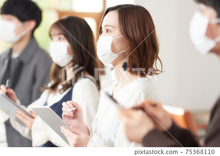 Seminar students wearing masks to take notes on tablets Seminar students wearing masks to take notes on tablets 75368110