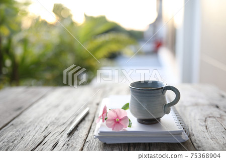 Asian clay ceramic cup and flower and notebook Asian clay ceramic cup and flower and notebook 75368904