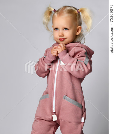 Portrait of a little preschooler girl in a warm 75369875