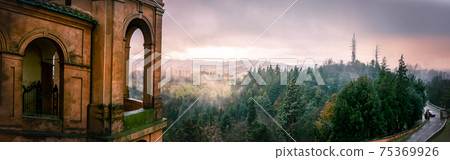 panoramic view of Colli Bolognesi hills at sunset from the arcades San Luca basilica, horizontal panoramic view of Colli Bolognesi hills at sunset from the arcades San Luca basilica, horizontal 75369926