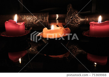 Candlelight illuminates the scabbard of an ancient Chinese sword with dragon 75369988
