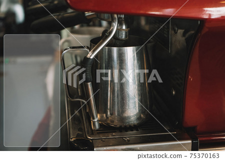 Old coffee machine, with one iron mug, espresso is poured into it Old coffee machine, with one iron mug, espresso is poured into it 75370163